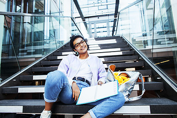 Image showing young cute indian girl at university building sitting on stairs 