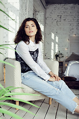 Image showing young pretty woman in her bedroom sitting in chair, lifestyle people concept