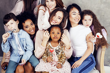 Image showing Lifestyle and people concept: young pretty diversity nations woman with different age children celebrating on birth day party together happy smiling, making selfie. African-american, asian and caucasi