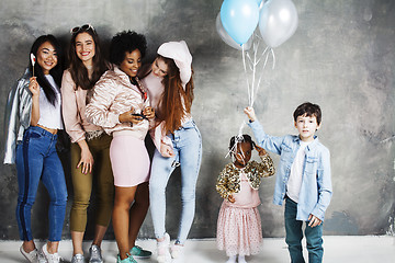 Image showing Lifestyle and people concept: young pretty diversity nations woman with different age children celebrating on birth day party together happy smiling, making selfie. African-american, asian and caucasi