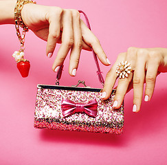 Image showing little girl stuff for princess, woman hands holding small cute handbag with jewelry and manicure, luxury lifestyle concept close up