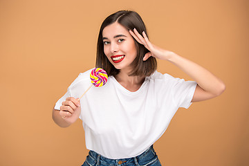 Image showing The young woman with colorful lollipop