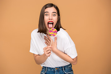 Image showing The young woman with colorful lollipop