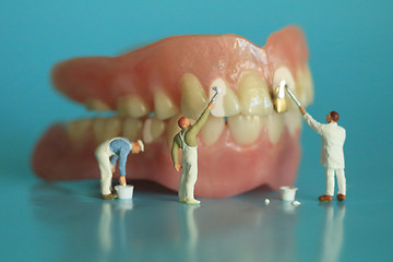 Image showing Miniature Workers Performing Dental Procedures. Dental Office Ar