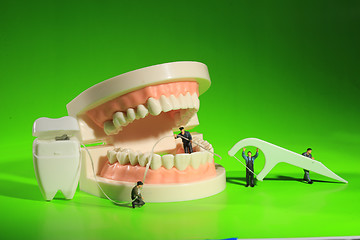 Image showing Miniature Workers Performing Dental Procedures. Dental Office Ar