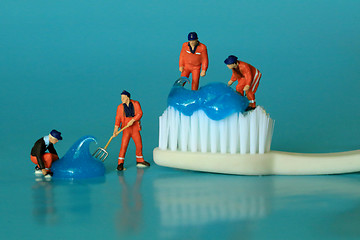 Image showing Miniature Workers Performing Dental Procedures. Dental Office Ar