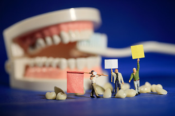 Image showing Miniature Workers Performing Dental Procedures. Dental Office Ar