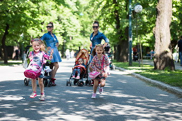 Image showing twins mother with children  in city park