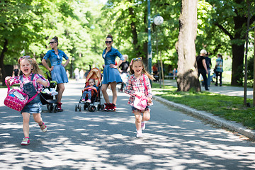 Image showing twins mother with children  in city park