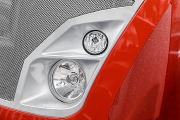 Image showing Headlight of a red car