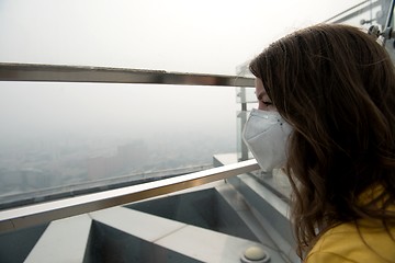 Image showing Woman in medical mask against the air pollution