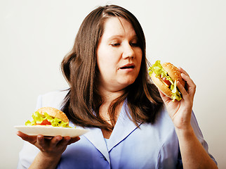 Image showing fat white woman having choice between hamburger and salad close 