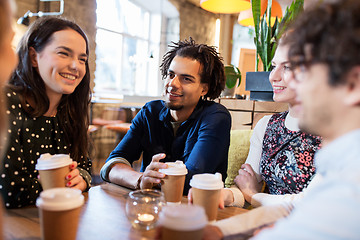 Image showing happy friends drinking coffee at restaurant