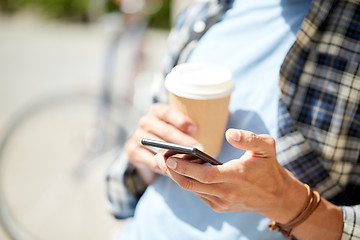 Image showing man with smartphone and coffee on city street