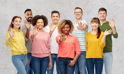 Image showing international group of happy people waving hand