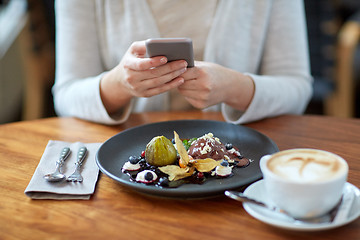 Image showing woman with smartphone photographing food at cafe