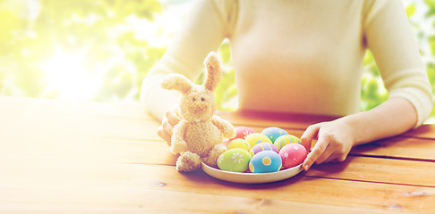 Image showing close up of woman hands with easter eggs and bunny