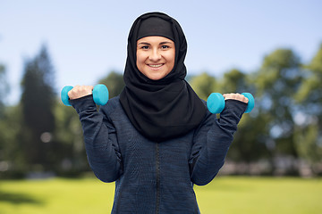 Image showing muslim woman in hijab with dumbbells doing fitness