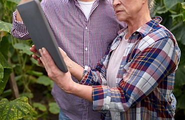 Image showing senior couple with tablet pc at farm greenhouse