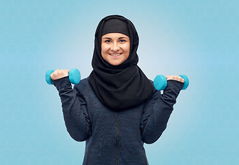 Image showing muslim woman in hijab with dumbbells doing fitness