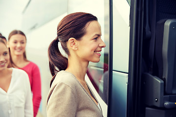 Image showing group of happy passengers boarding travel bus