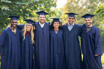 Image showing happy students or bachelors in mortar boards