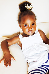 Image showing little pretty african american girl sitting in white chair weari