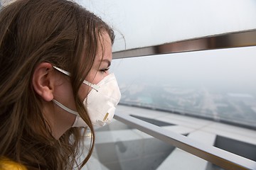 Image showing Woman in medical mask against the air pollution