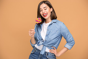 Image showing The young woman with colorful lollipop