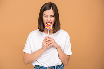 Image showing The young woman with colorful lollipop