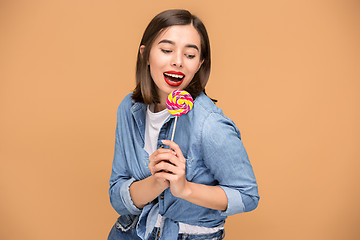 Image showing The young woman with colorful lollipop