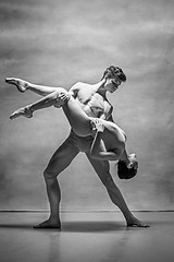 Image showing Couple of ballet dancers posing over gray background