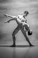 Image showing Couple of ballet dancers posing over gray background