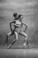 Image showing Couple of ballet dancers posing over gray background