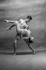 Image showing Couple of ballet dancers posing over gray background