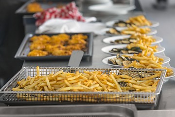 Image showing French fries and meat on the table