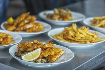 Image showing French fries and meat on the table