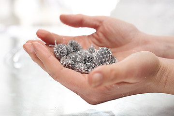 Image showing Woman decorate baubles. Christmas tree decorations