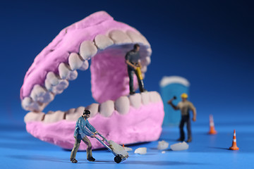 Image showing Miniature Workers Performing Dental Procedures. Dental Office Ar