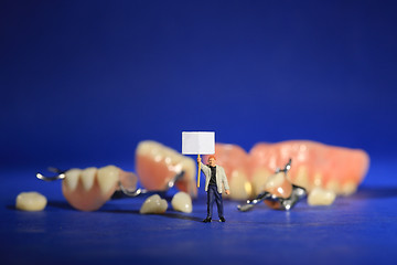 Image showing Miniature Workers Performing Dental Procedures. Dental Office Ar