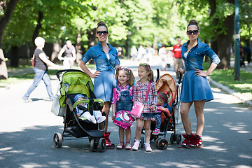 Image showing twins mother with children  in city park