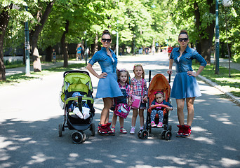 Image showing twins mother with children  in city park