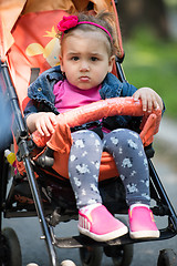 Image showing baby girl sitting in the pram