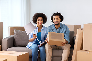 Image showing happy couple with stuff moving to new home