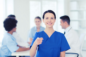 Image showing happy doctor over group of medics at hospital