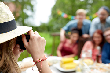 Image showing woman photographing friends at summer garden party