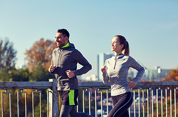 Image showing happy couple running outdoors