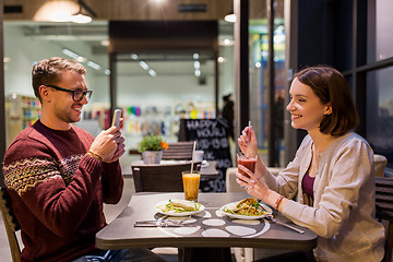 Image showing happy couple having dinner at vegan restaurant