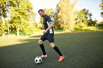 Image showing soccer player playing with ball on football field