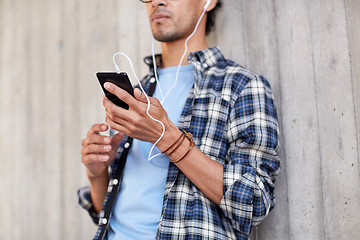 Image showing man with earphones and smartphone listening music